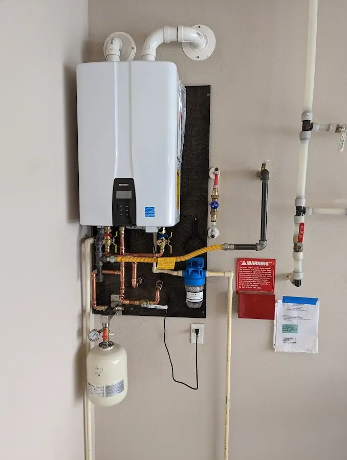 Professional plumber installing copper piping in a Welby home